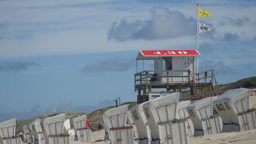 Information sign by buildings against sky