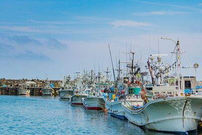 Fishing boats moored at harbor in city