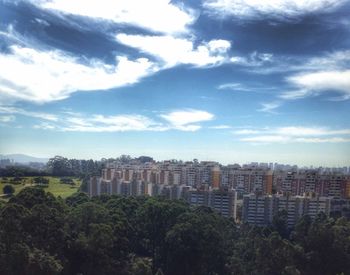 Buildings against cloudy sky