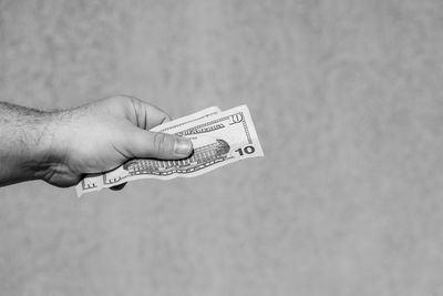 Cropped hand holding paper currency