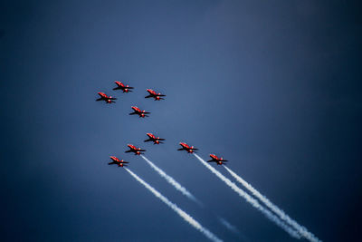 Low angle view of airshow against sky