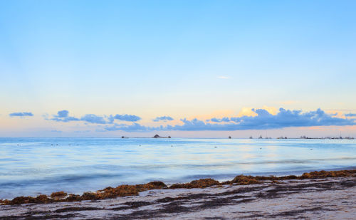 Scenic view of sea against sky at sunset