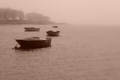 Boat moored on sea against sky