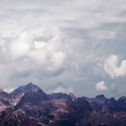 Scenic view of mountains against cloudy sky