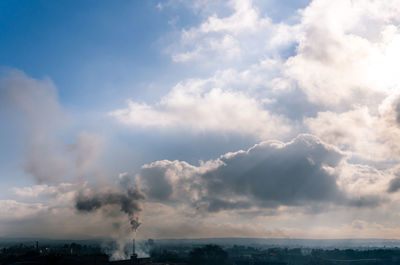 Smoke emitting from sea against sky