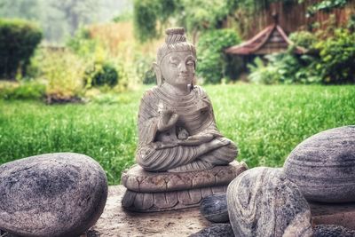 Statue of buddha against trees