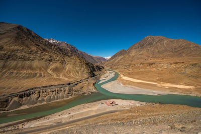 Scenic view of mountains against clear blue sky