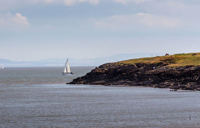 Sailboat on sea against sky