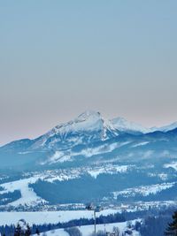 Scenic view of snowcapped mountains against clear sky