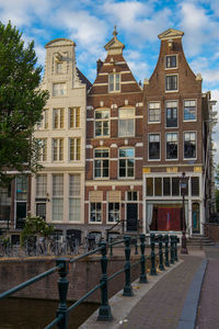 Residential building by street against sky