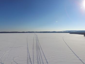 Scenic view of snow covered landscape against clear sky