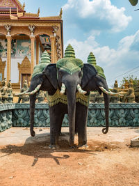 Low angle view of elephant statue against cloudy sky