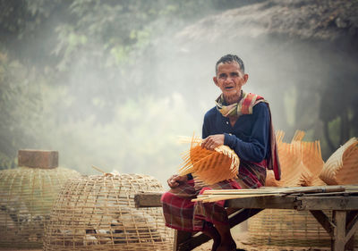 Portrait of man preparing wicker basket