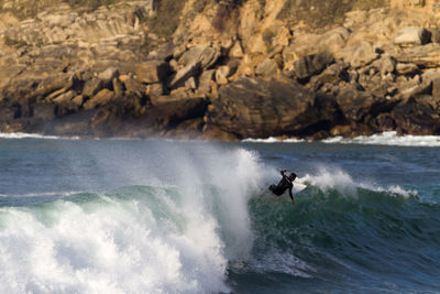 Scenic view of waves splashing on rocks