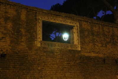 Low angle view of illuminated building against sky at night