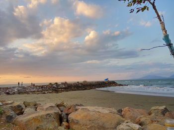 Scenic view of beach against sky during sunset