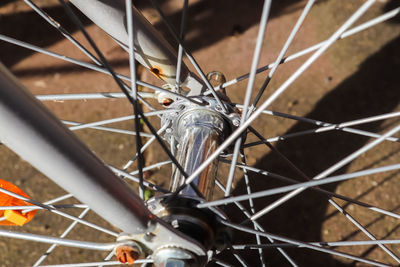 Selective focus close up view at a bicycle wheel with metal spokes