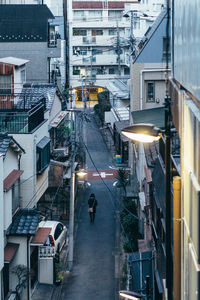 High angle view of people walking on street amidst buildings