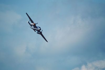 Low angle view of airplane flying against sky