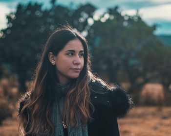 Portrait of beautiful young woman standing outdoors