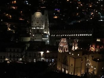 High angle view of illuminated buildings in city at night