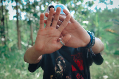 Midsection of child hand on plant