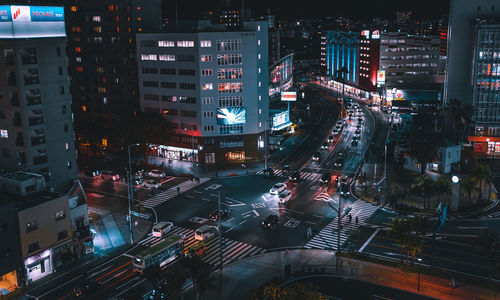 High angle view of illuminated city street and buildings at night