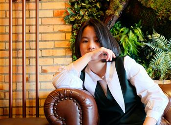 Portrait of young woman sitting outdoors