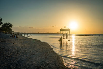 Scenic view of beach against sky during sunset