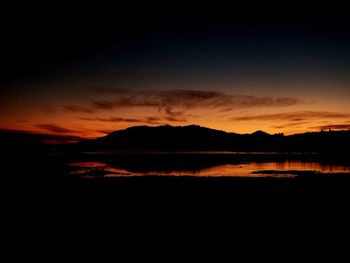 Scenic view of lake against romantic sky at sunset