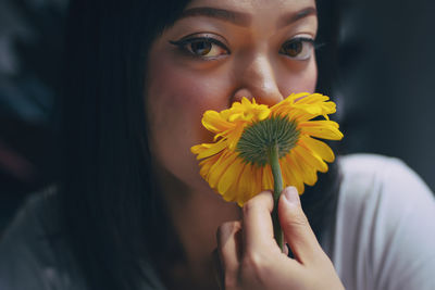Close-up portrait of a hand holding yellow flower