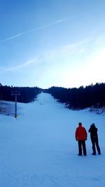 Ski lift on snowcapped field against sky