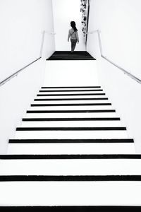 Low angle view of woman standing on stairs