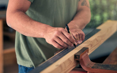 Midsection of man working in workshop