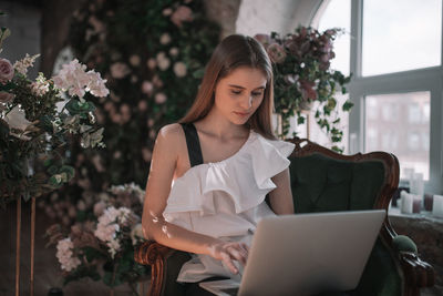 Young woman using mobile phone outdoors