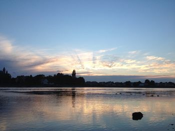 Scenic view of lake at sunset