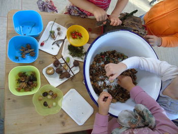 High angle view of siblings sitting on table