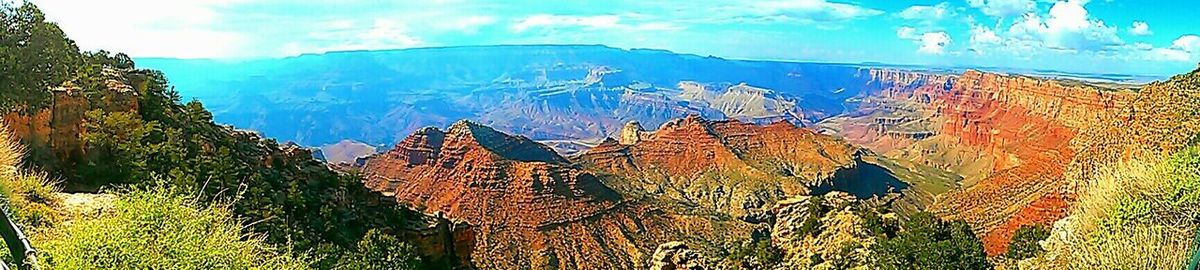 Scenic view of mountains against blue sky