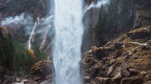 Low angle view of waterfall against sky