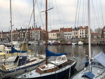 Sailboats moored in harbor