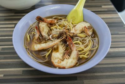 Close-up of served prawns noodle soup