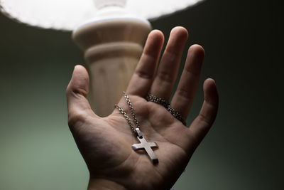 Close-up of man holding crucifix