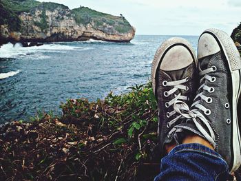 Low section of person on sea shore