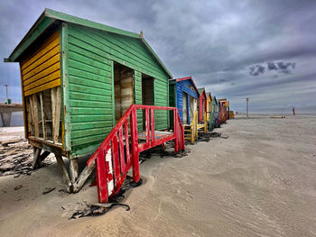 Houses on beach against sky
