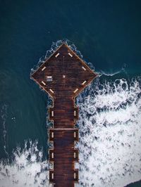 Pier over sea against sky at night