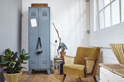 Empty chairs and table against wall at home