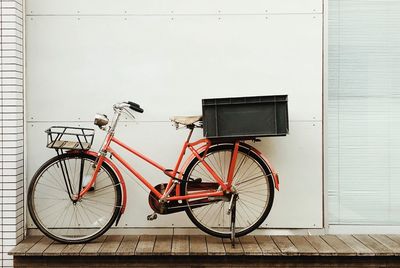 Bicycle parked against wall in building