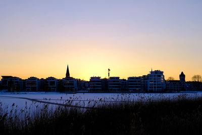 Buildings in city at sunset