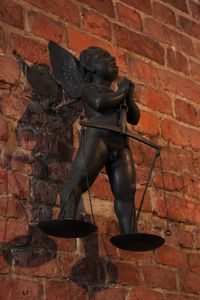 Close-up of statue against brick wall
