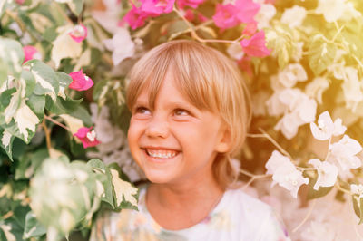 Defocused blurred portrait of face candid little happy smiling five year old blonde kid boy